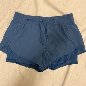 Sky Blue Workout Shorts With Drawstring Waist And Built-In Shorts With Pockets